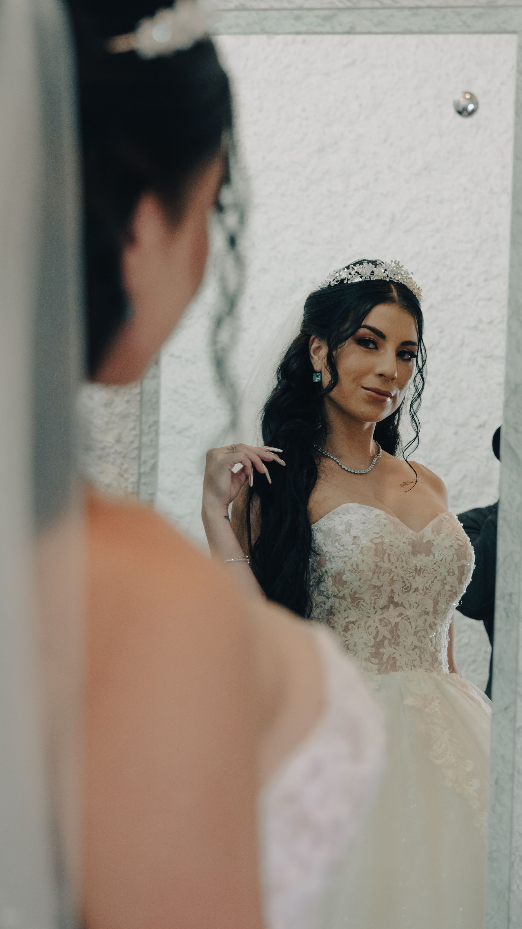 Bride checking her look in a mirror