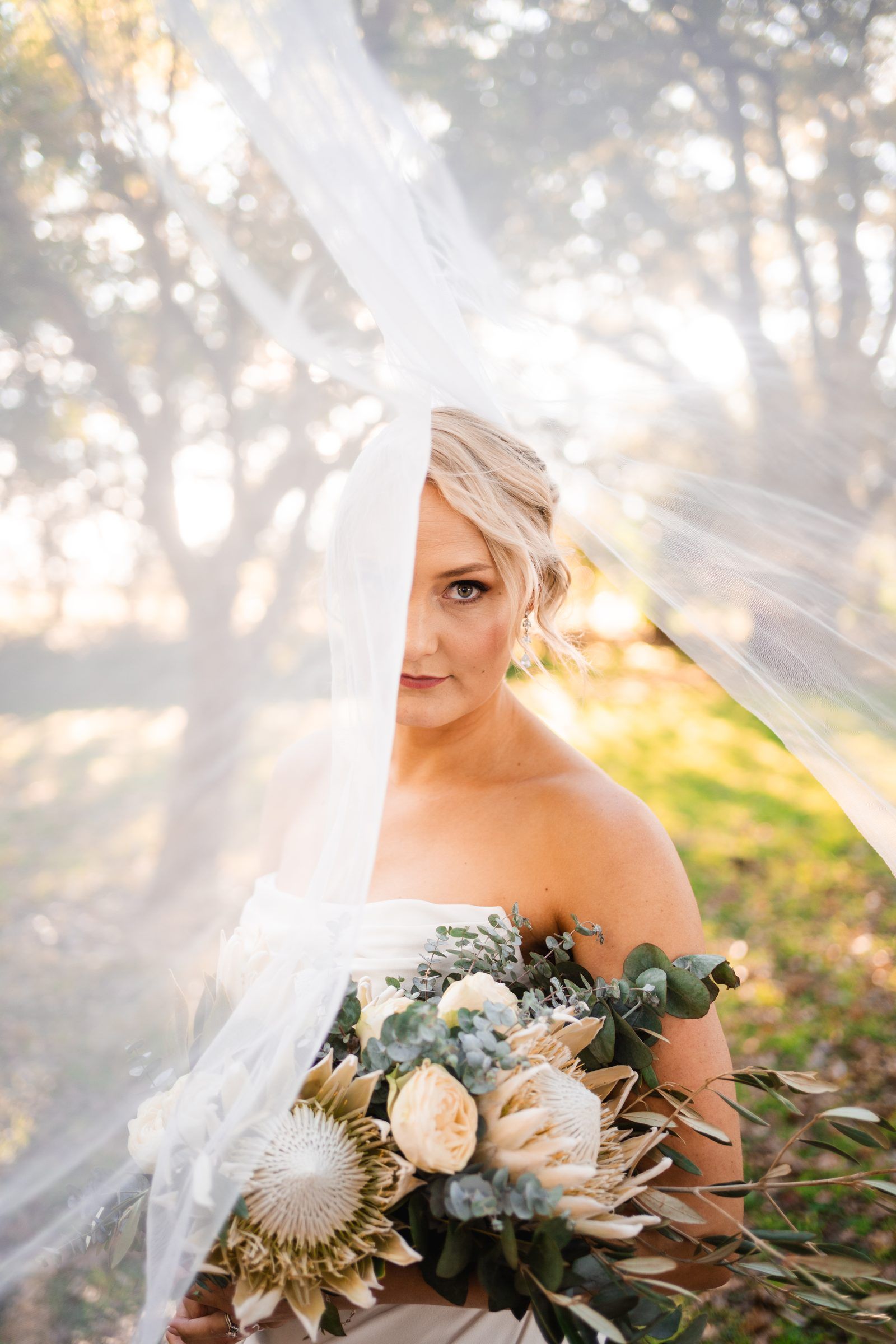 Bride under her veil in golden afternoon light