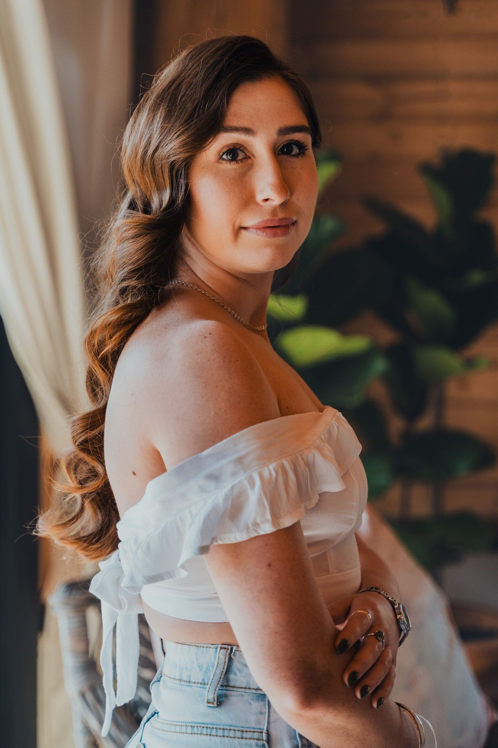 Portrait of a woman with soft glam makeup and loose curls