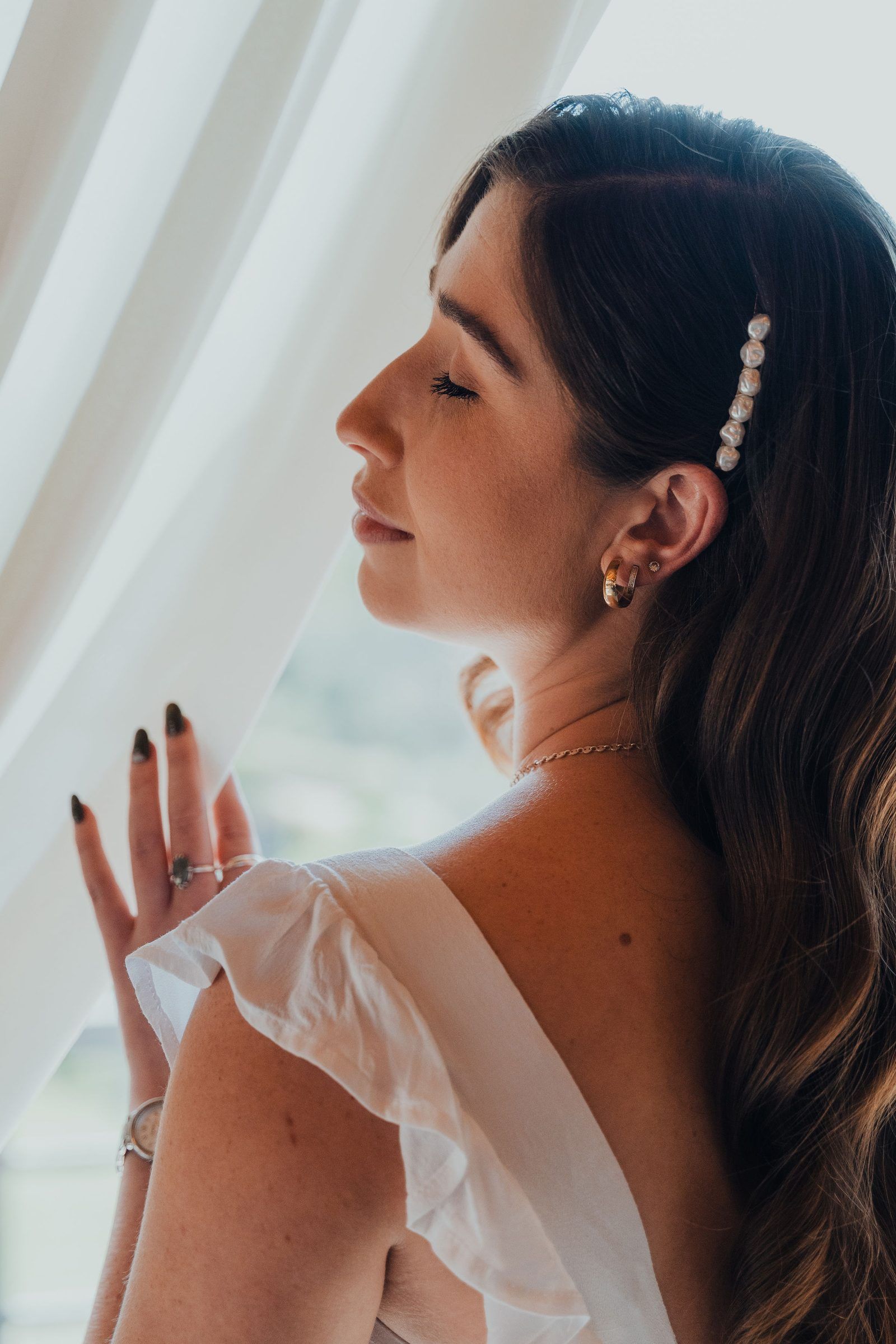 Portrait of a woman with a pearl hair clip and sleek dark hair